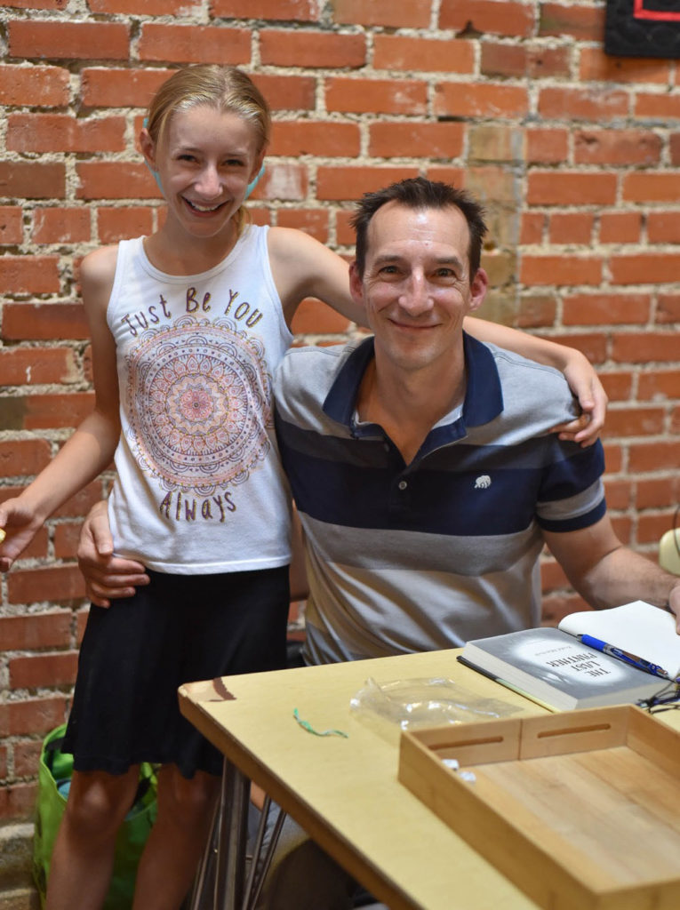 Todd Mitchell and his daughter at book signing