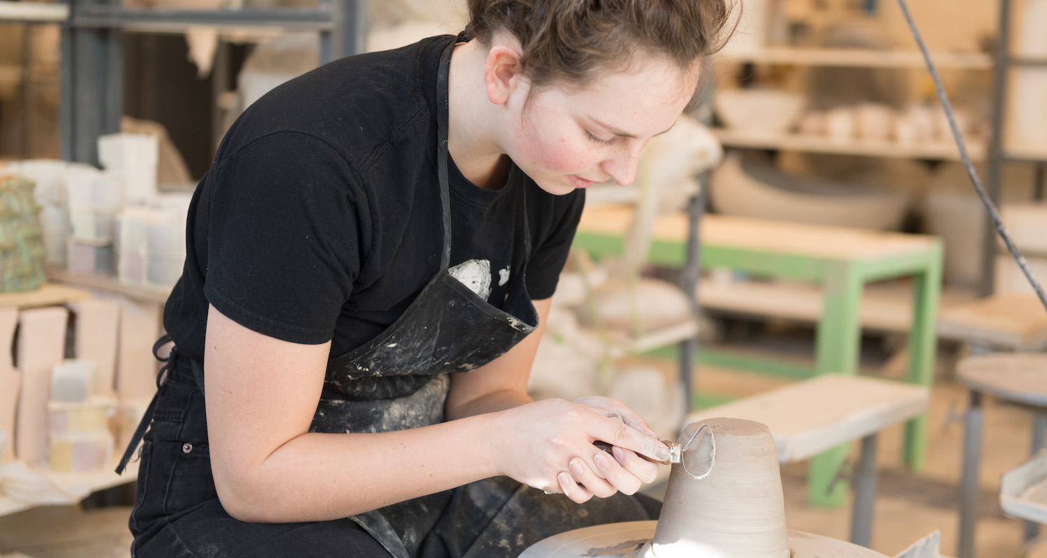 Student working on pottery