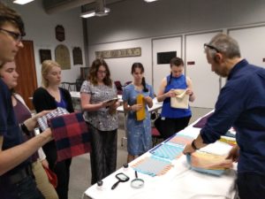 Cozart alongside other Deerfield fellows examining textiles
