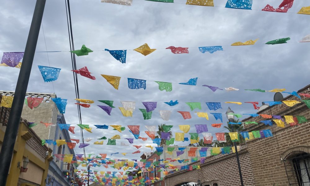 Flags above a city street in Todos Santos