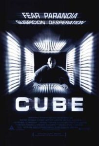 Movie poster for "Cube" featuring the words FEAR PARANOIA SUSPICION DESPERATION and a scared man looking stuck inside a square with lights all around