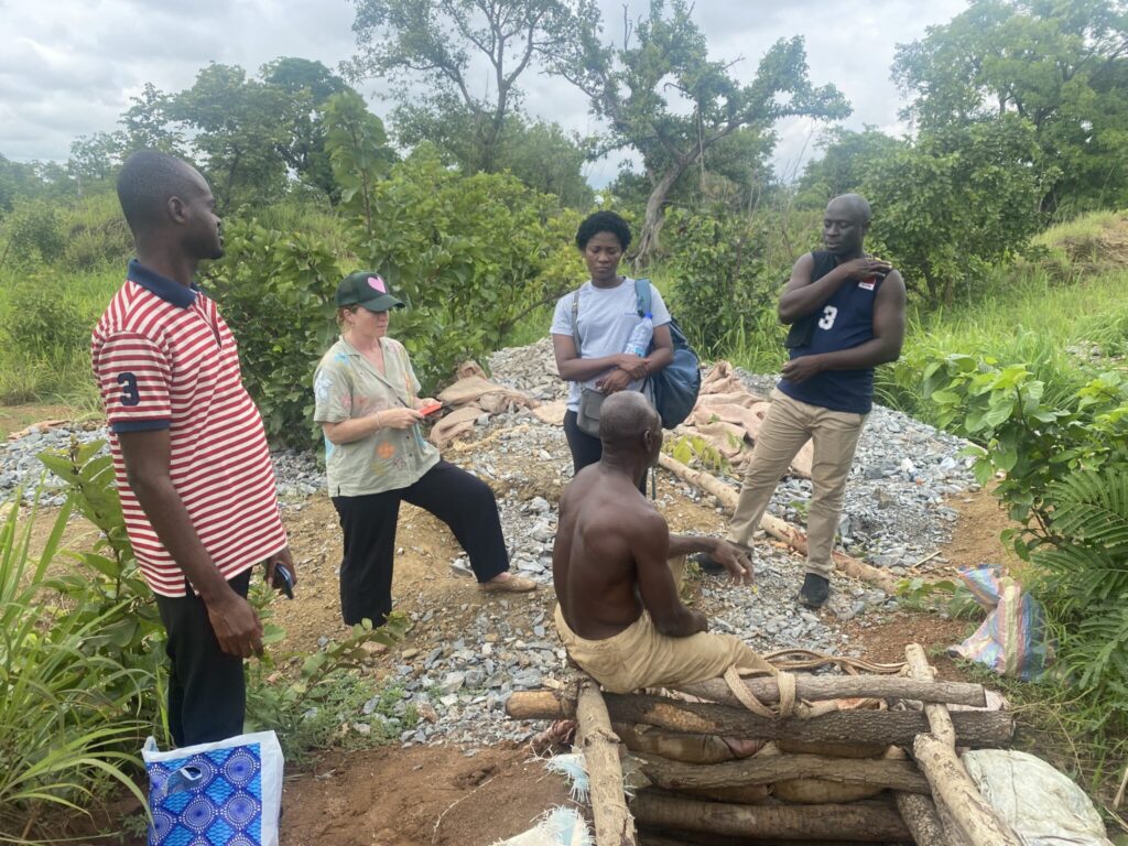Emmanuel Effah, Bernadette Atosona, another man, and Heidi Hausermann speaking with a hard rock miner about mercury use in northern Ghana.