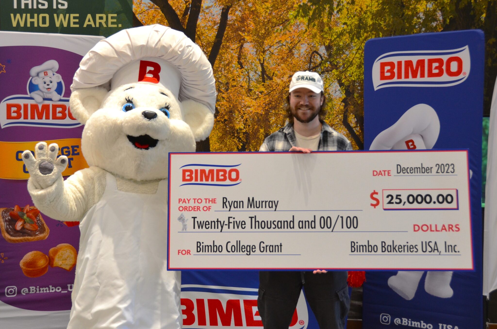 Ryan Murray ('23) posing with Bimbo USA mascot and large $25,000 check.