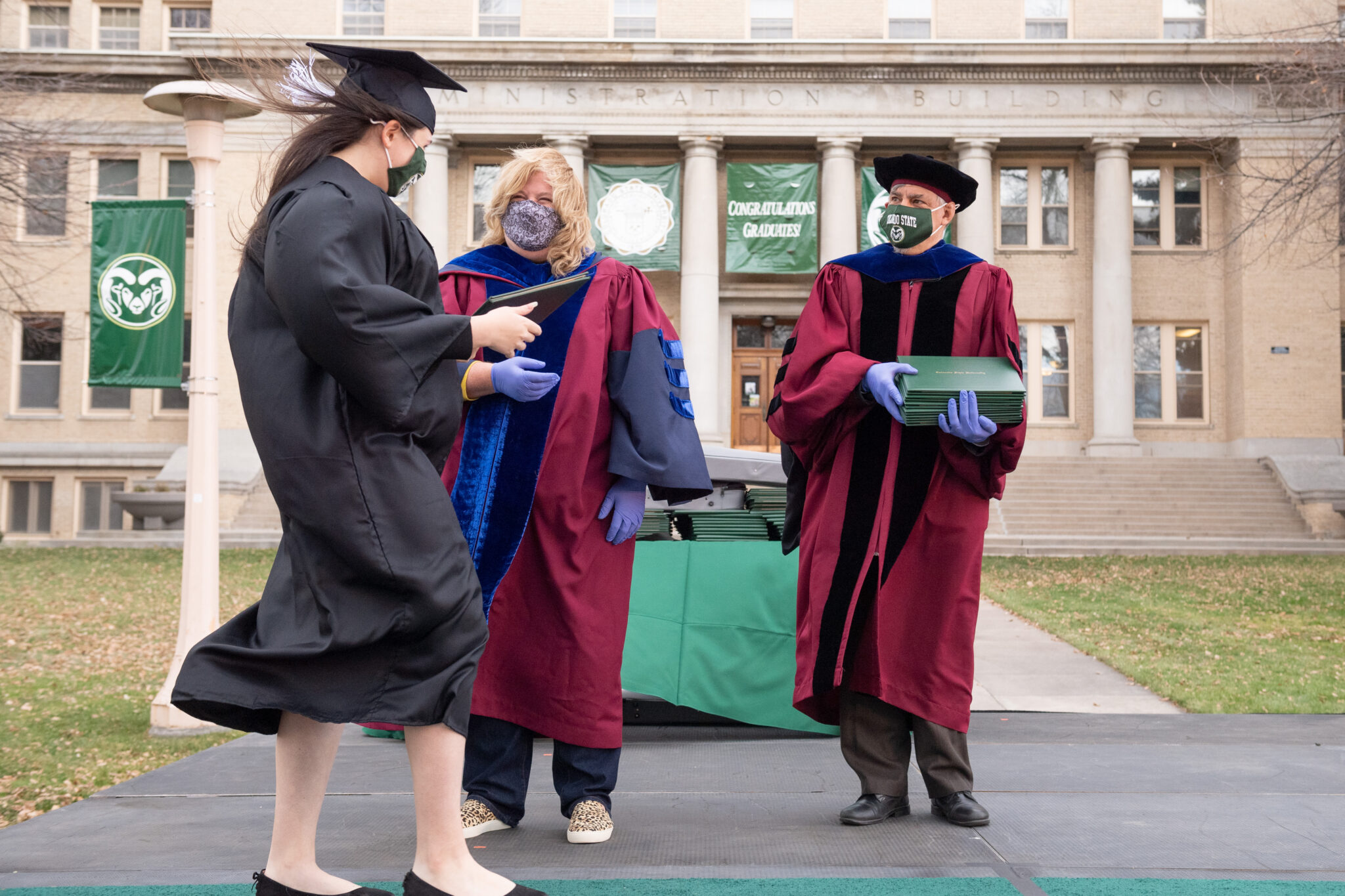 Dean Ben Withers and Anthropology and Geography Chair Mica Glantz handing out diplomas at CSU's Walk Around the Oval event during the COVID pandemic.